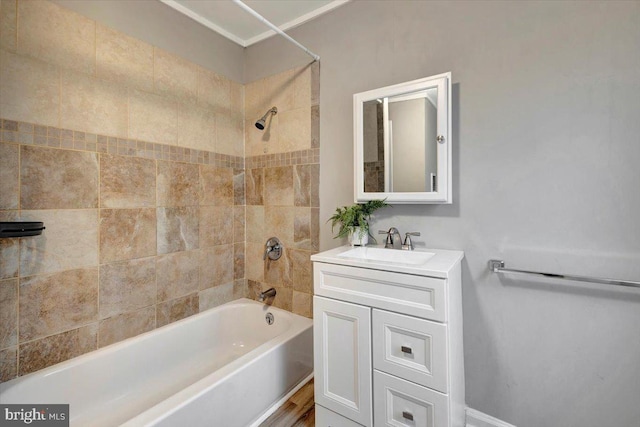 bathroom with tiled shower / bath and vanity