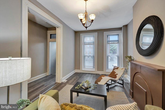 interior space featuring dark wood-type flooring and a notable chandelier