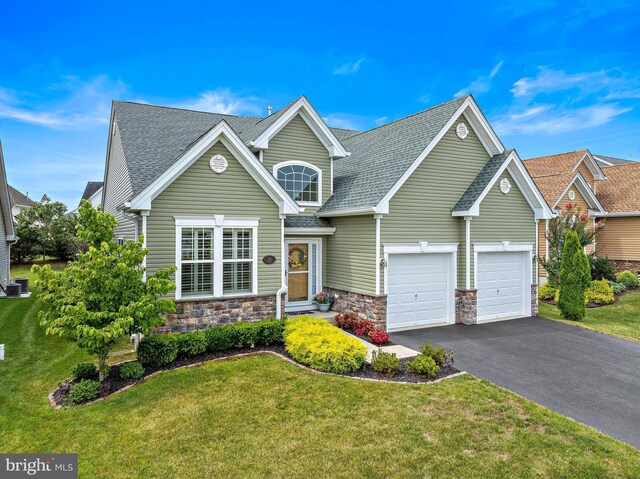 view of front of property featuring a front yard and a garage