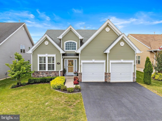 view of front of home with a garage and a front lawn