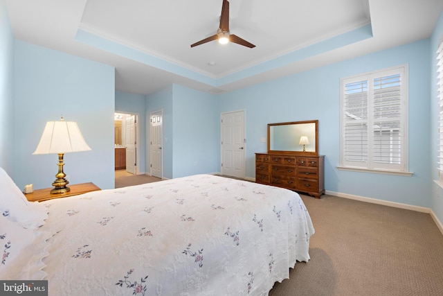 carpeted bedroom with ceiling fan, connected bathroom, and a tray ceiling