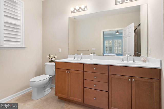 bathroom featuring toilet, vanity, and tile patterned flooring