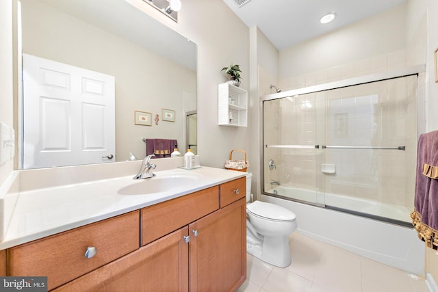 full bathroom featuring tile patterned floors, enclosed tub / shower combo, vanity, and toilet