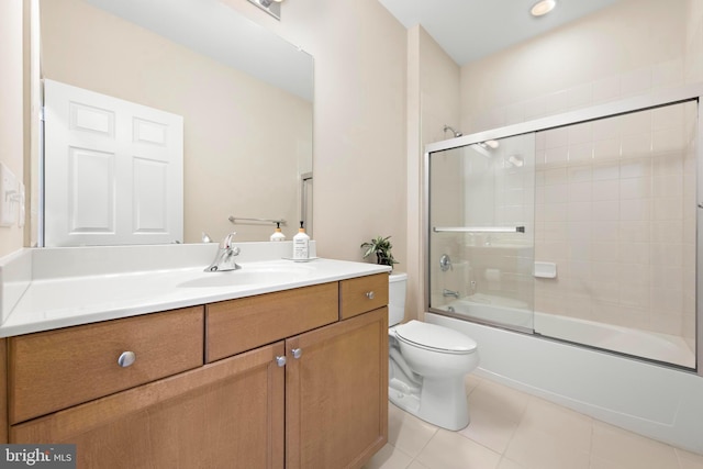 full bathroom with vanity, shower / bath combination with glass door, tile patterned floors, and toilet