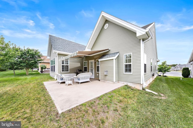 rear view of property with a yard and a patio