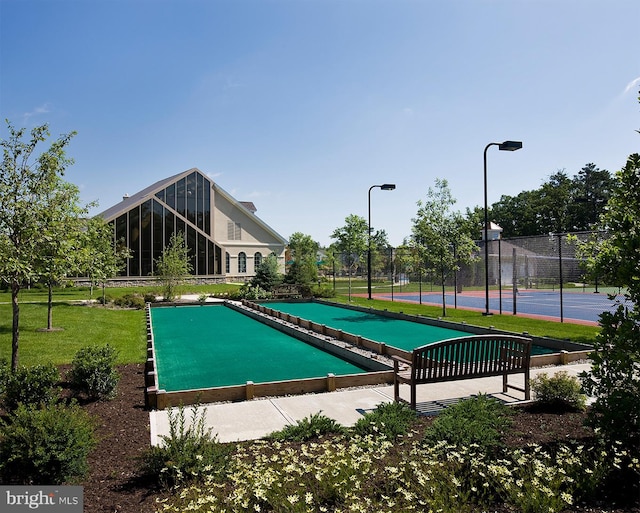 view of swimming pool with tennis court