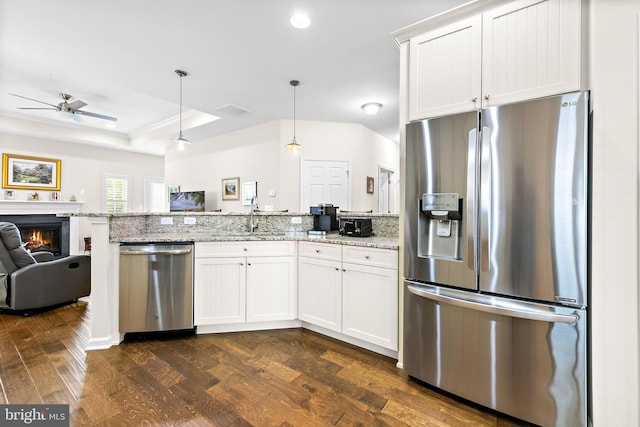 kitchen featuring white cabinetry, light stone countertops, hanging light fixtures, and appliances with stainless steel finishes