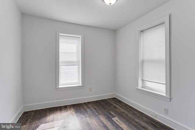 spare room with dark hardwood / wood-style flooring