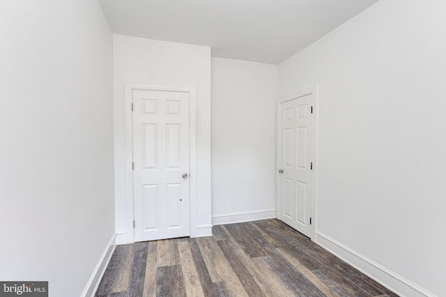 empty room featuring dark wood-type flooring