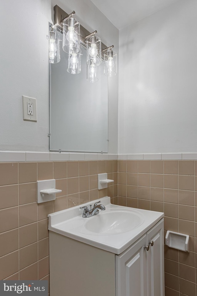 bathroom featuring vanity and tile walls