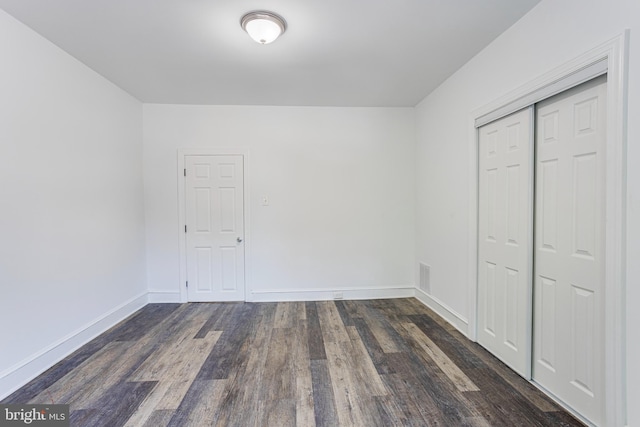 interior space featuring dark hardwood / wood-style floors and a closet