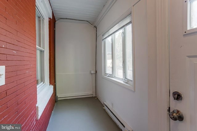 interior space featuring a baseboard radiator and brick wall