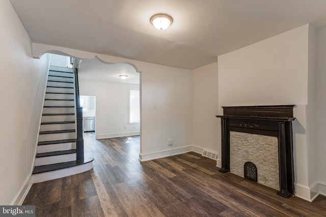 unfurnished living room with dark hardwood / wood-style floors