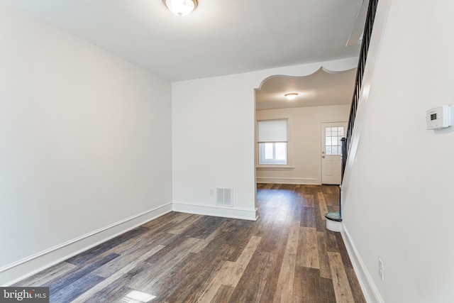 unfurnished room featuring dark wood-type flooring