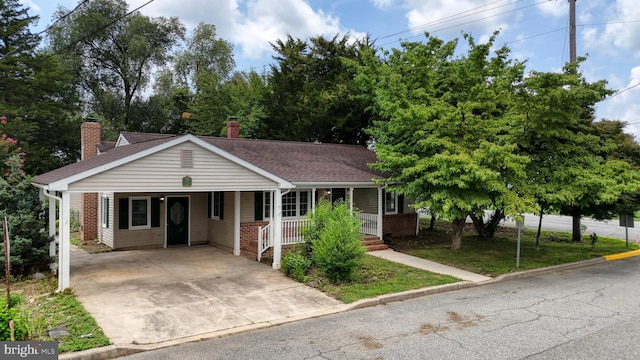 view of front of property featuring a carport and covered porch