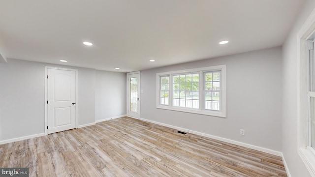 empty room with light hardwood / wood-style flooring