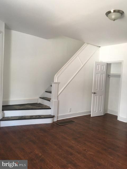 stairway featuring hardwood / wood-style floors