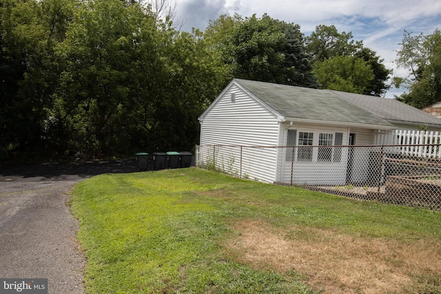 view of side of property with a yard