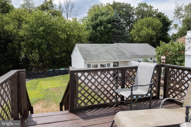 wooden terrace with a yard and an outdoor structure