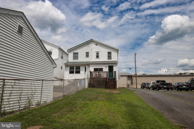 view of front facade with an outdoor structure and a front yard