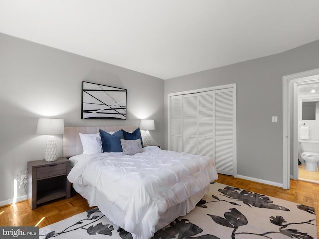 bedroom featuring light parquet flooring, a closet, and connected bathroom