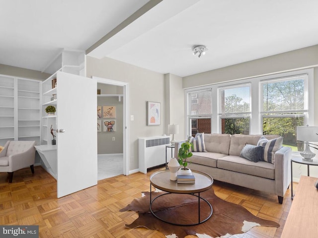 living room with light parquet floors and radiator heating unit