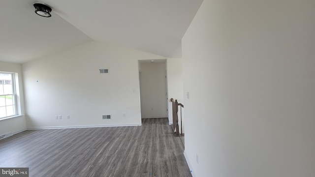 empty room with hardwood / wood-style flooring and lofted ceiling