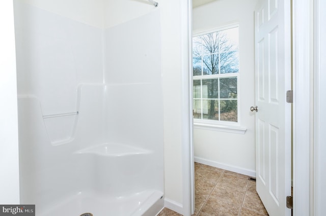 bathroom featuring tile patterned flooring and a shower