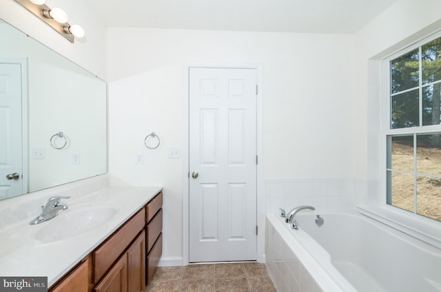 bathroom featuring vanity, tile patterned floors, and a relaxing tiled tub