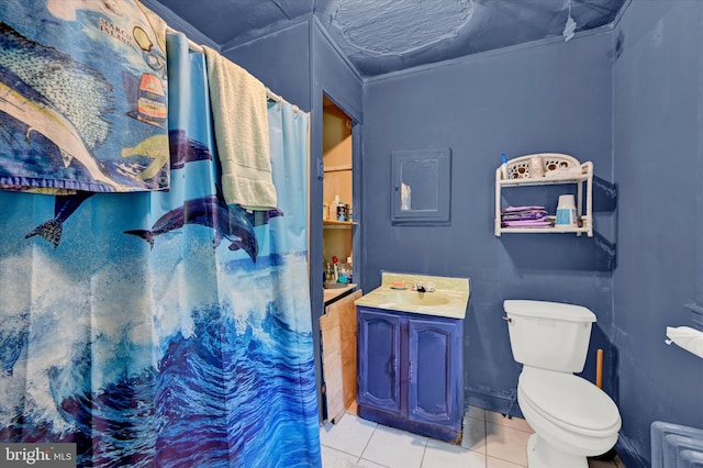 bathroom with tile patterned flooring, toilet, and vanity