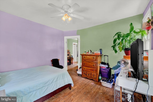 bedroom with ceiling fan and wood-type flooring