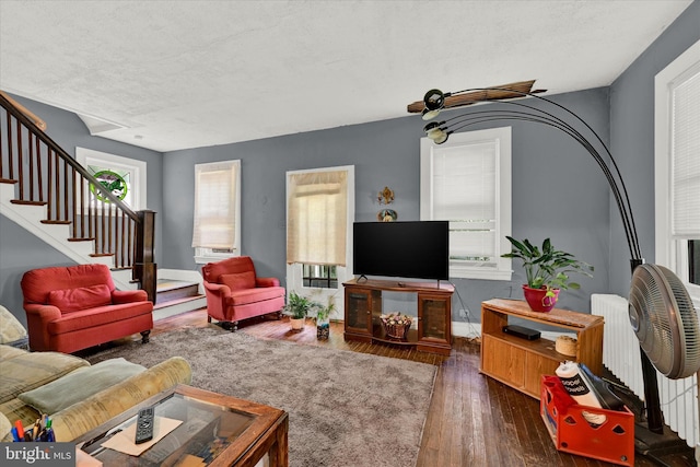 living room with dark hardwood / wood-style flooring and radiator