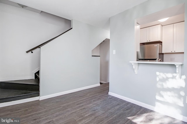 unfurnished living room with dark hardwood / wood-style flooring