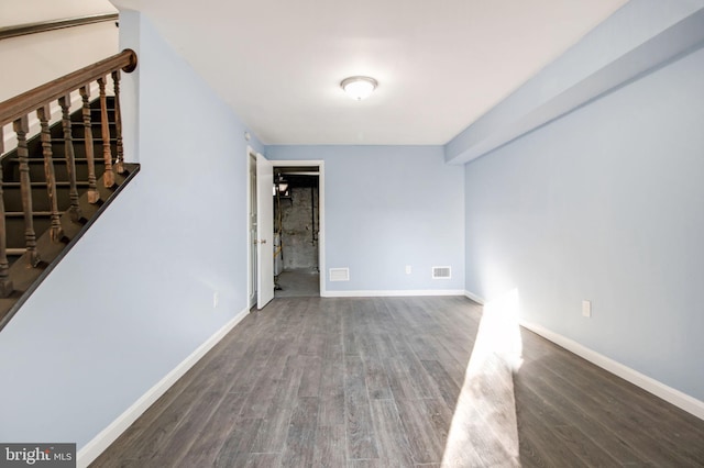 empty room featuring dark wood-type flooring