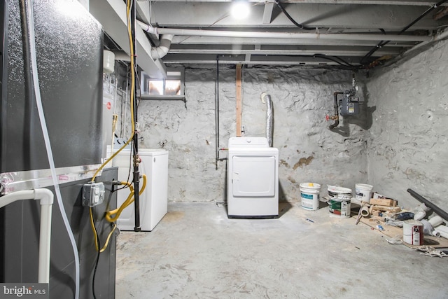 basement featuring washer and dryer and heating unit