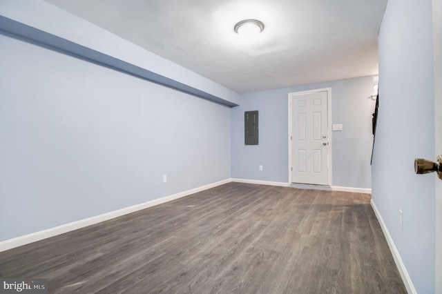 interior space featuring electric panel and dark hardwood / wood-style flooring