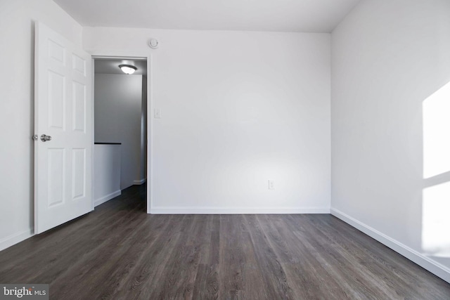 empty room featuring dark hardwood / wood-style flooring