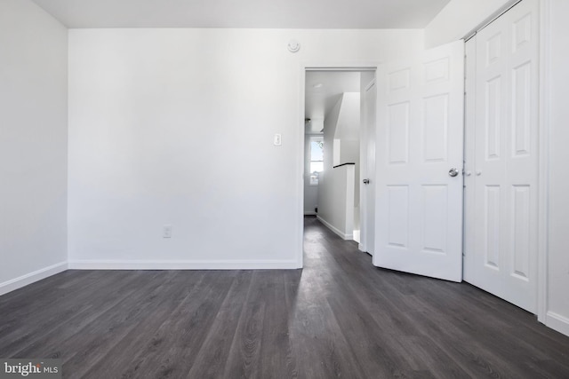 unfurnished room featuring dark wood-type flooring