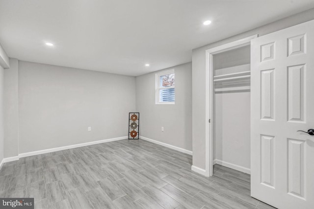 unfurnished bedroom featuring light wood-type flooring and a closet