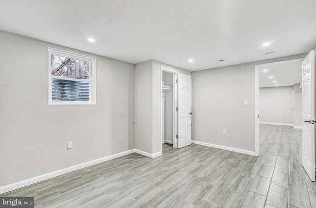 basement with light hardwood / wood-style floors