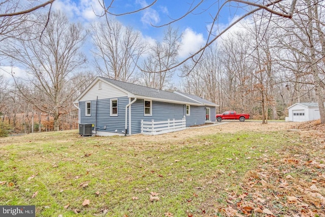 view of home's exterior with central AC and a lawn