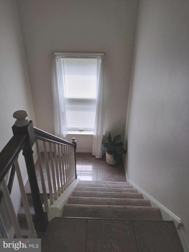 stairway featuring tile patterned flooring