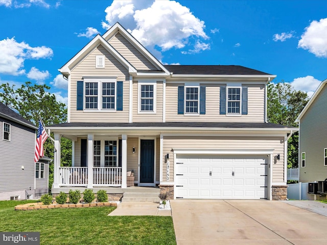 view of front of home featuring a front lawn, a porch, and a garage