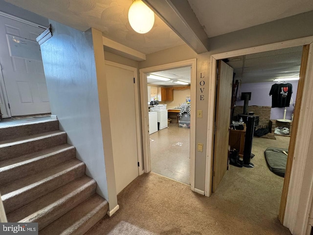 hallway featuring light colored carpet