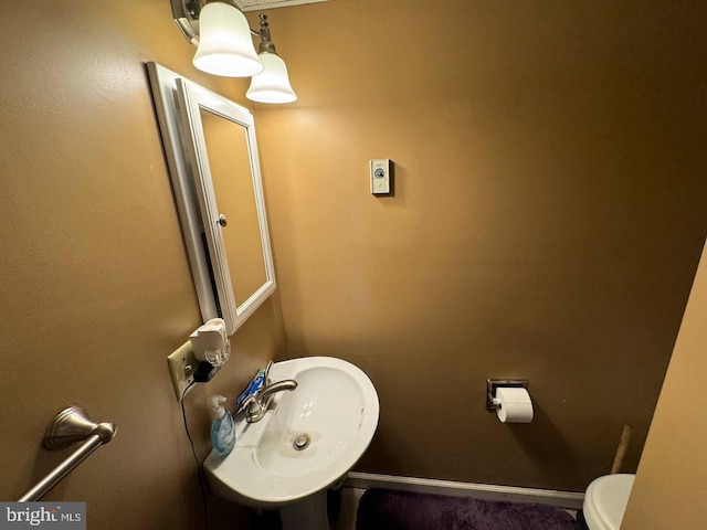 bathroom with toilet and sink