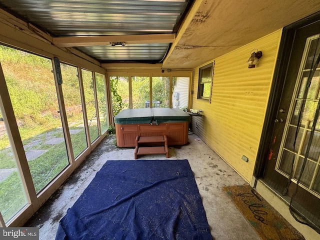 sunroom / solarium featuring beam ceiling