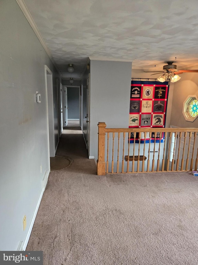 unfurnished room with ceiling fan, carpet flooring, and crown molding