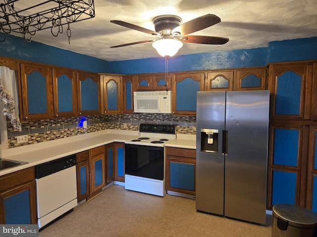 kitchen featuring ceiling fan, tasteful backsplash, and white appliances