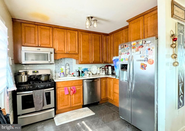 kitchen with sink, appliances with stainless steel finishes, and tasteful backsplash