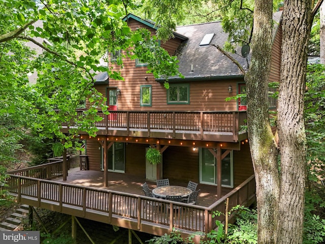 rear view of property featuring a deck